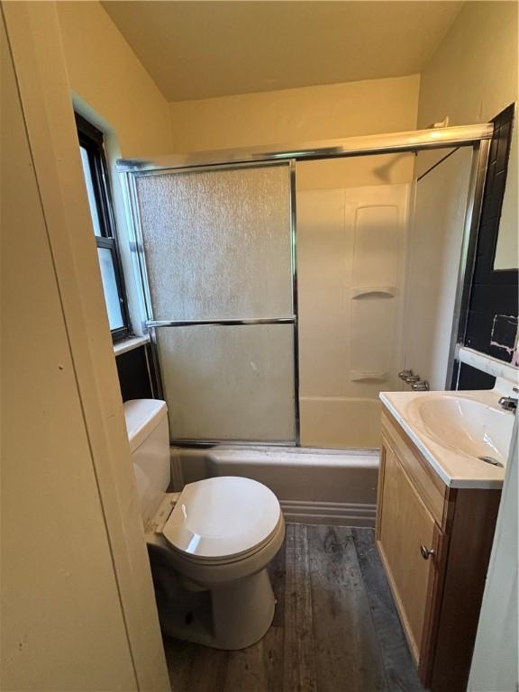 7707-7708-7710 Forest Way, Homewood-Brushton, PA 15208 - bathroom featuring toilet, vanity, bath / shower combo with glass door, and wood finished floors