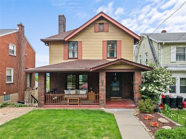 952 Jackman Ave, Avalon, PA 15202 - view of front of property with a front yard, covered porch, brick siding, and a shingled roof