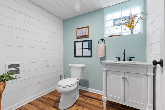 952 Jackman Ave, Avalon, PA 15202 - bathroom featuring toilet, vanity, wood finished floors, a wall mounted AC, and baseboards