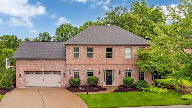 104 Southridge Dr, Cranberry Twp, PA 16066 - colonial inspired home featuring concrete driveway, a front lawn, roof with shingles, and brick siding