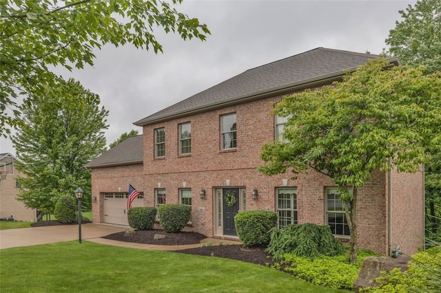 104 Southridge Dr, Cranberry Twp, PA 16066 - colonial inspired home with concrete driveway, a front yard, an attached garage, and brick siding