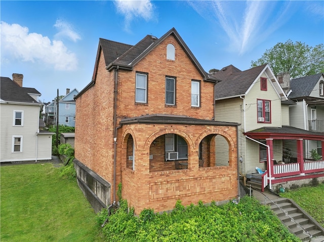 342 E 11th Ave, Homestead, PA 15120 - view of front facade featuring brick siding, a porch, a front lawn, and cooling unit