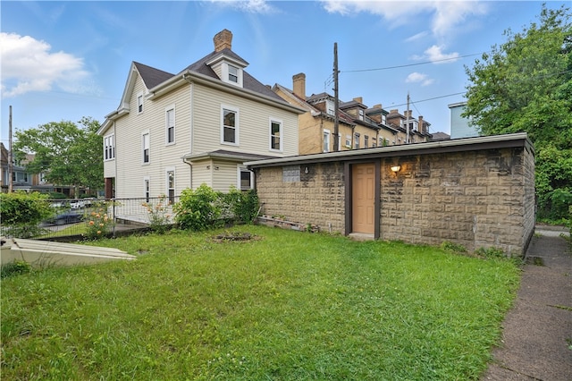 342 E 11th Ave, Homestead, PA 15120 - rear view of house featuring a chimney and stone siding