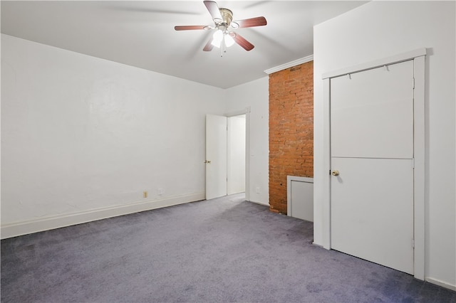 342 E 11th Ave, Homestead, PA 15120 - unfurnished bedroom featuring carpet floors, ceiling fan, and brick wall