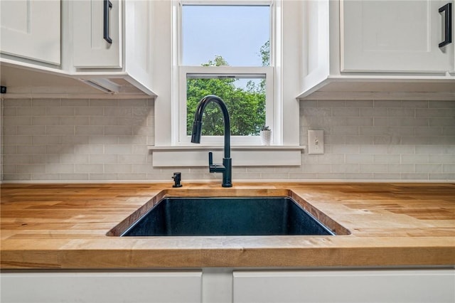 510 Central Ave E, Washington Boro, PA 15301 - kitchen view of wood counters, a sink, white cabinetry, and decorative backsplash