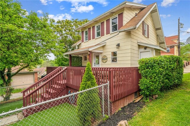 510 Central Ave E, Washington Boro, PA 15301 - view of front of home featuring a garage, a shingled roof, and a deck