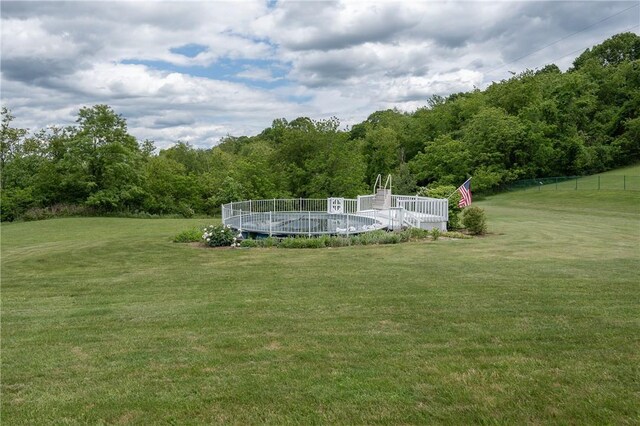 302 Shutt Rd, Hempfield Twp Wml, PA 15601 - view of yard with a covered pool and a wooded view