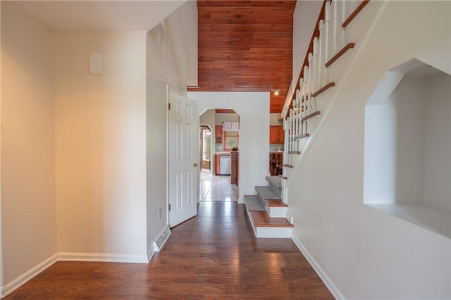 302 Shutt Rd, Hempfield Twp Wml, PA 15601 - entrance foyer featuring arched walkways, dark wood-style flooring, baseboards, stairs, and a towering ceiling