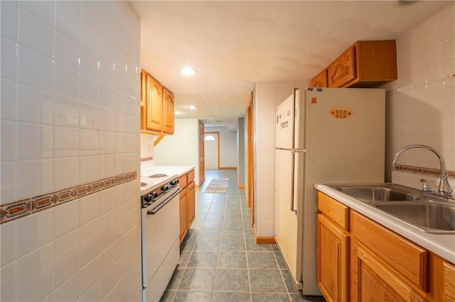 302 Shutt Rd, Hempfield Twp Wml, PA 15601 - kitchen with white appliances, a sink, tile walls, dark tile patterned floors, and light countertops