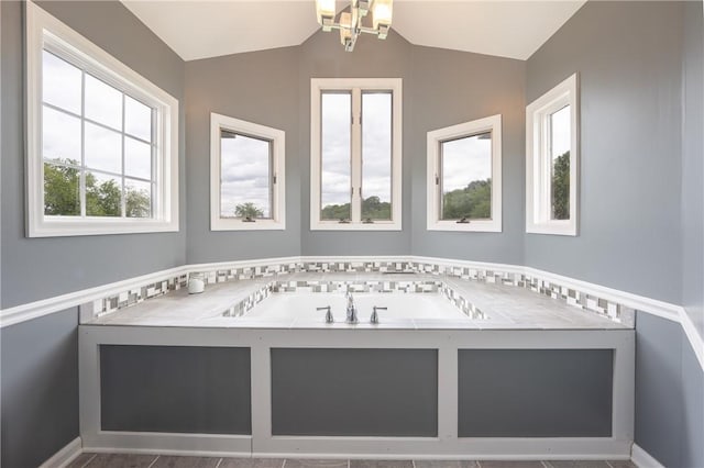 302 Shutt Rd, Hempfield Twp Wml, PA 15601 - bathroom featuring vaulted ceiling, a bath, a chandelier, and baseboards