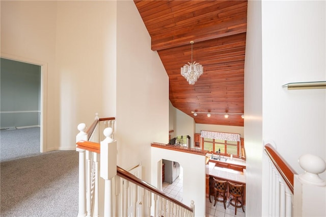 302 Shutt Rd, Hempfield Twp Wml, PA 15601 - stairs with wooden ceiling, carpet, a chandelier, high vaulted ceiling, and baseboards