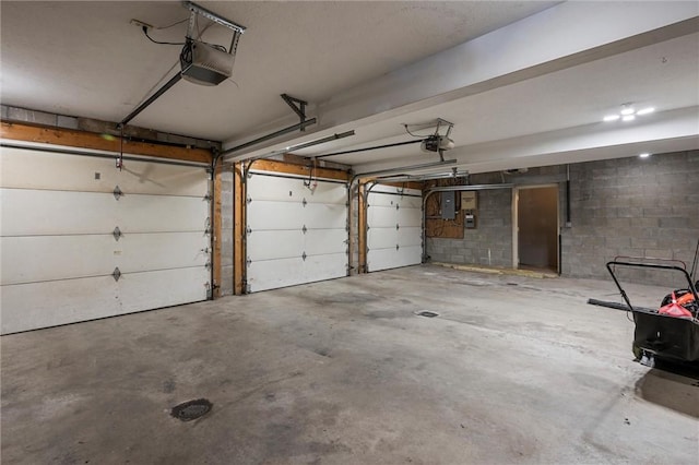 547 Mercer Rd, Twp Of But Ne, PA 16001 - garage with a garage door opener, concrete block wall, and electric panel