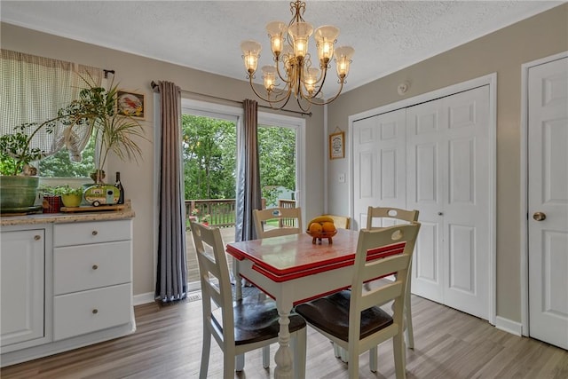 125 Spruce St, Brighton Twp, PA 15009 - dining room featuring a chandelier, light wood-style floors, a textured ceiling, and baseboards