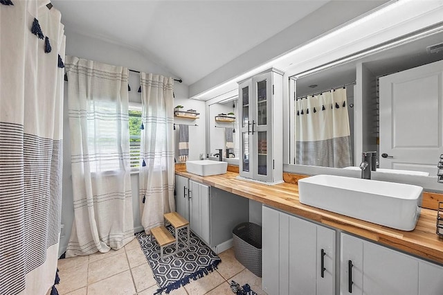 330 Earlwood Rd, Penn Hills, PA 15235 - bathroom with lofted ceiling, double vanity, and tile patterned flooring