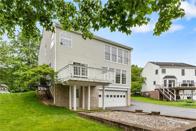 117 Trailside Ct, North Fayette, PA 15108 - rear view of property featuring a garage, driveway, a lawn, and a deck
