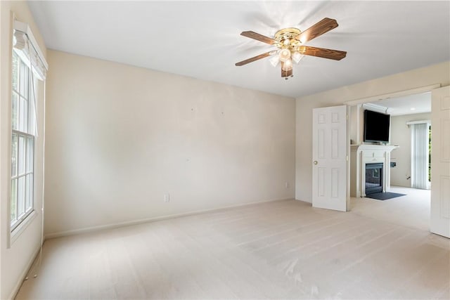 117 Trailside Ct, North Fayette, PA 15108 - empty room featuring a fireplace with flush hearth, ceiling fan, light colored carpet, and baseboards