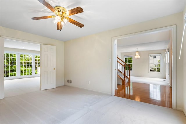 117 Trailside Ct, North Fayette, PA 15108 - carpeted spare room with stairs and a ceiling fan