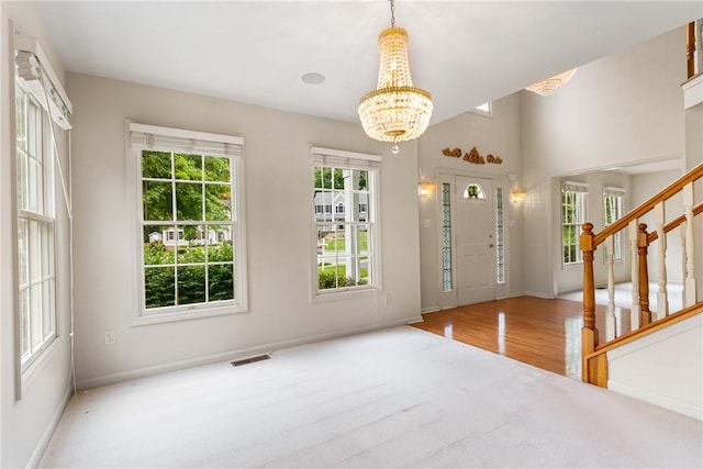 117 Trailside Ct, North Fayette, PA 15108 - entryway featuring a chandelier, stairway, baseboards, and wood finished floors