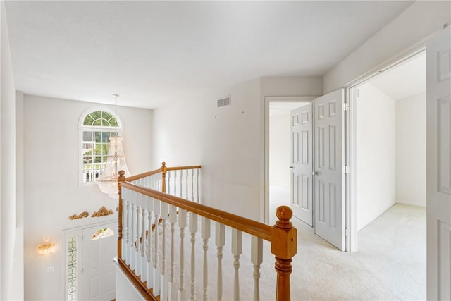 117 Trailside Ct, North Fayette, PA 15108 - hall with an upstairs landing, light carpet, and a chandelier