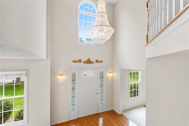 117 Trailside Ct, North Fayette, PA 15108 - foyer featuring a high ceiling, a chandelier, wood finished floors, and baseboards