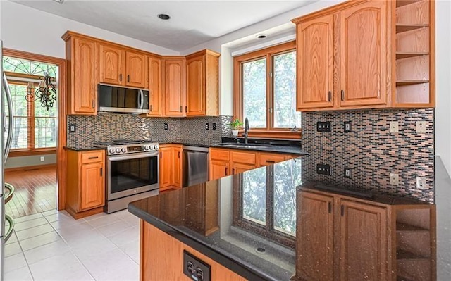 103 Mcdonnell Ln, Middlesex Twp, PA 16002 - kitchen featuring stainless steel appliances, a sink, light tile patterned flooring, and decorative backsplash