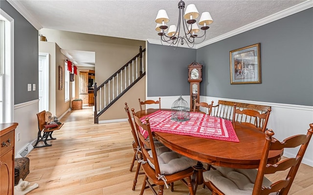 133 Miller Rd, Clinton Twp, PA 16055 - dining space featuring a chandelier, crown molding, stairs, light wood finished floors, and a textured ceiling