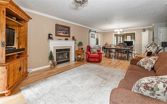 133 Miller Rd, Clinton Twp, PA 16055 - living room with light wood-style floors, a chandelier, crown molding, a fireplace with flush hearth, and a textured ceiling