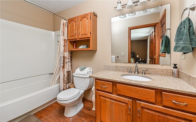 133 Miller Rd, Clinton Twp, PA 16055 - full bathroom with vanity, shower / bath combo with shower curtain, toilet, wood finished floors, and a textured ceiling