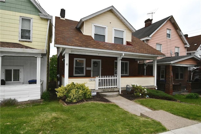 1312 Kelton Ave, Dormont, PA 15216 - view of front of property with covered porch, a front yard, and a chimney