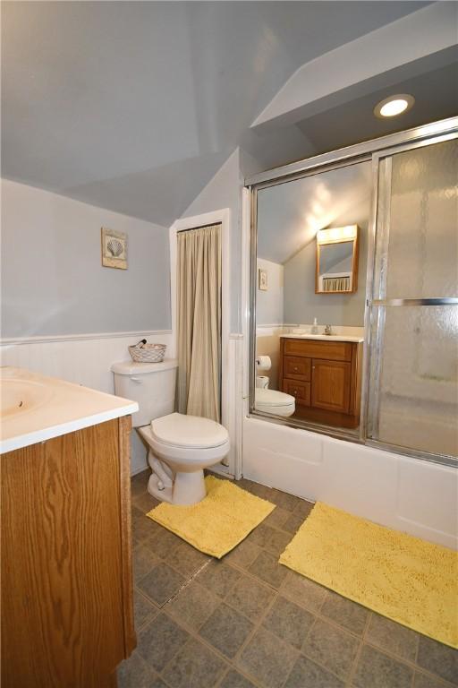 1312 Kelton Ave, Dormont, PA 15216 - full bath with lofted ceiling, toilet, vanity, and shower / bath combination with glass door