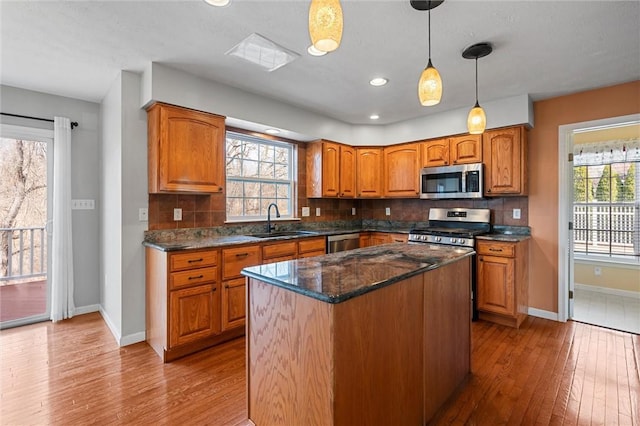 115 Tartan Dr, Hempfield Twp Wml, PA 15601 - kitchen with appliances with stainless steel finishes, a sink, hardwood / wood-style flooring, baseboards, and brown cabinets
