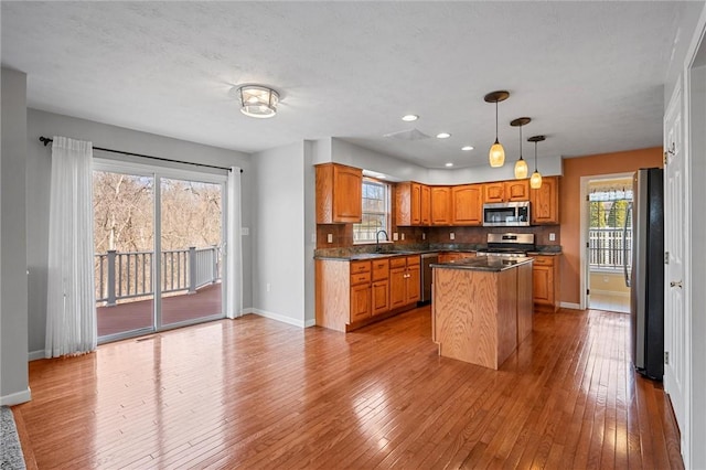 115 Tartan Dr, Hempfield Twp Wml, PA 15601 - kitchen with appliances with stainless steel finishes, a sink, baseboards, wood-type flooring, and a kitchen island