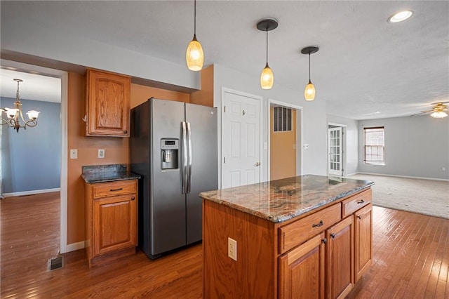 115 Tartan Dr, Hempfield Twp Wml, PA 15601 - kitchen with stainless steel fridge, baseboards, hardwood / wood-style flooring, brown cabinetry, and open floor plan