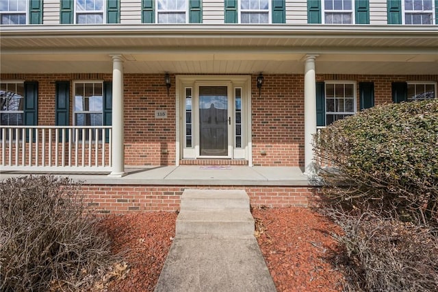 115 Tartan Dr, Hempfield Twp Wml, PA 15601 - property entrance with a porch and brick siding