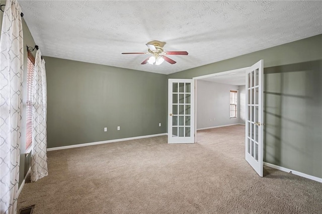 115 Tartan Dr, Hempfield Twp Wml, PA 15601 - carpeted empty room with french doors, a ceiling fan, baseboards, and a textured ceiling