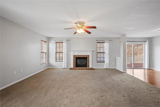115 Tartan Dr, Hempfield Twp Wml, PA 15601 - unfurnished living room with a ceiling fan, baseboards, carpet flooring, and a brick fireplace