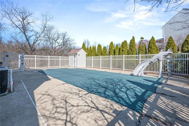 115 Tartan Dr, Hempfield Twp Wml, PA 15601 - view of swimming pool with a water slide, a patio area, central air condition unit, and an outbuilding