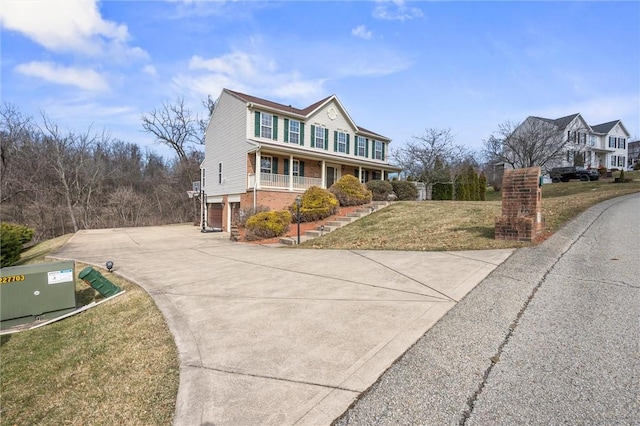 115 Tartan Dr, Hempfield Twp Wml, PA 15601 - view of front of property with covered porch, driveway, brick siding, a front yard, and a garage