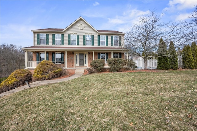 115 Tartan Dr, Hempfield Twp Wml, PA 15601 - colonial-style house with brick siding, covered porch, and a gate