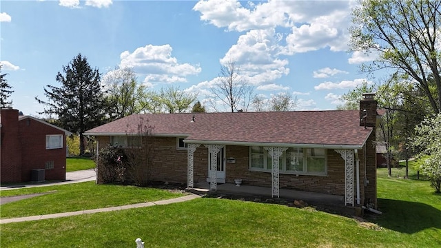 122 Burke Dr, Monroeville, PA 15146 - view of front of property featuring a front yard, a chimney, central AC unit, a porch, and a shingled roof