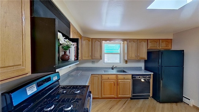 122 Burke Dr, Monroeville, PA 15146 - kitchen with black appliances, a sink, baseboard heating, light wood-style flooring, and light countertops