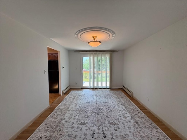 122 Burke Dr, Monroeville, PA 15146 - spare room featuring a baseboard radiator, light wood-style floors, and baseboards