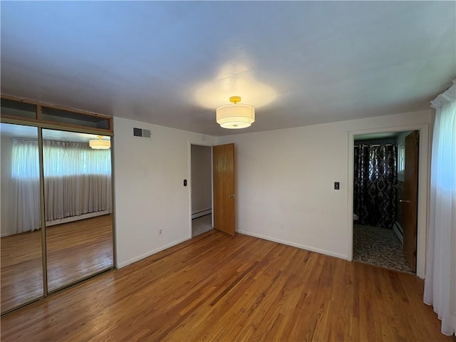 122 Burke Dr, Monroeville, PA 15146 - spare room with wood finished floors, baseboards, and a baseboard heating unit
