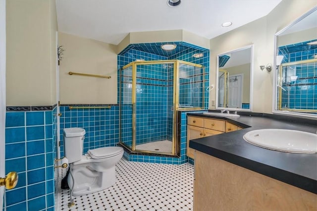 1167 Murray Hill Ave, Squirrel Hill, PA 15217 - bathroom with double vanity, toilet, a shower stall, tile patterned floors, and a wainscoted wall