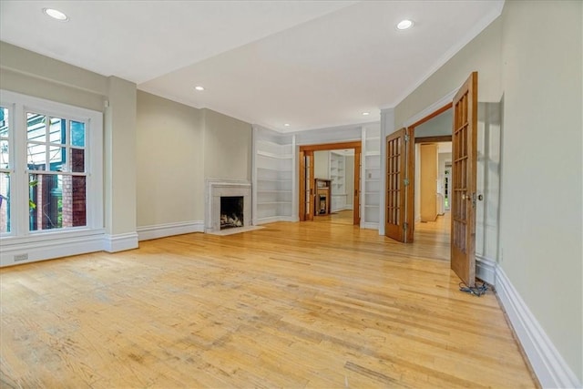 1167 Murray Hill Ave, Squirrel Hill, PA 15217 - unfurnished living room with recessed lighting, light wood-style floors, baseboards, built in shelves, and crown molding