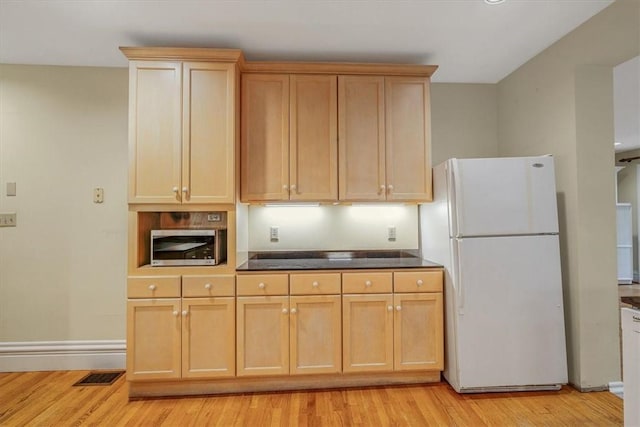 1167 Murray Hill Ave, Squirrel Hill, PA 15217 - kitchen featuring freestanding refrigerator, stainless steel microwave, light wood-style flooring, and baseboards