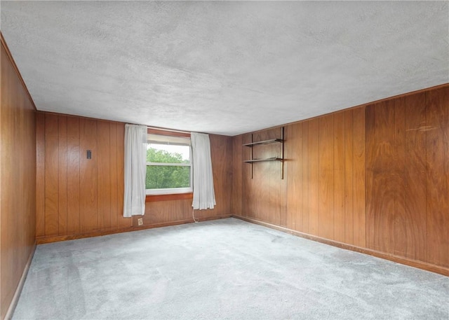 2555 Cole Rd, Marshall, PA 15090 - empty room featuring a textured ceiling, wooden walls, carpet, and baseboards