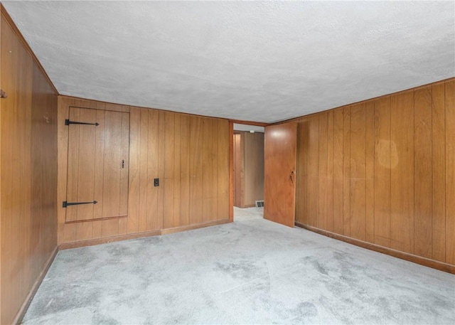 2555 Cole Rd, Marshall, PA 15090 - carpeted empty room featuring a textured ceiling and wood walls