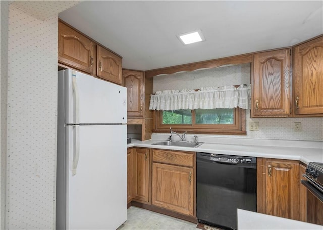 2555 Cole Rd, Marshall, PA 15090 - kitchen with black dishwasher, freestanding refrigerator, a sink, and brown cabinetry