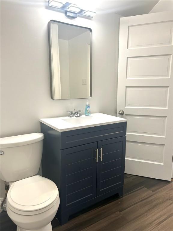 7 Fairview Pl, Union Twp Wsh, PA 15038 - half bathroom featuring vanity, toilet, and wood finished floors